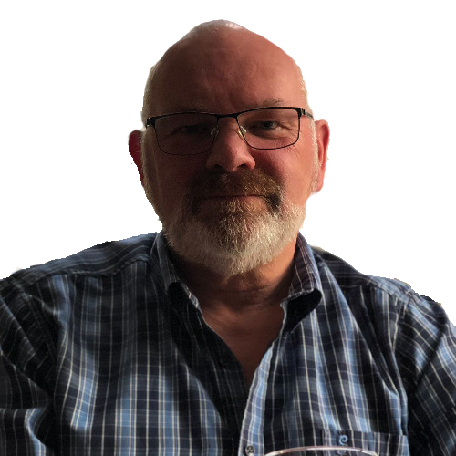 A smiling male with glasses and beard wearing a check shirt looking at the camera.